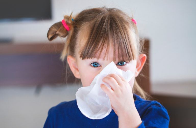 Child blowing her nose